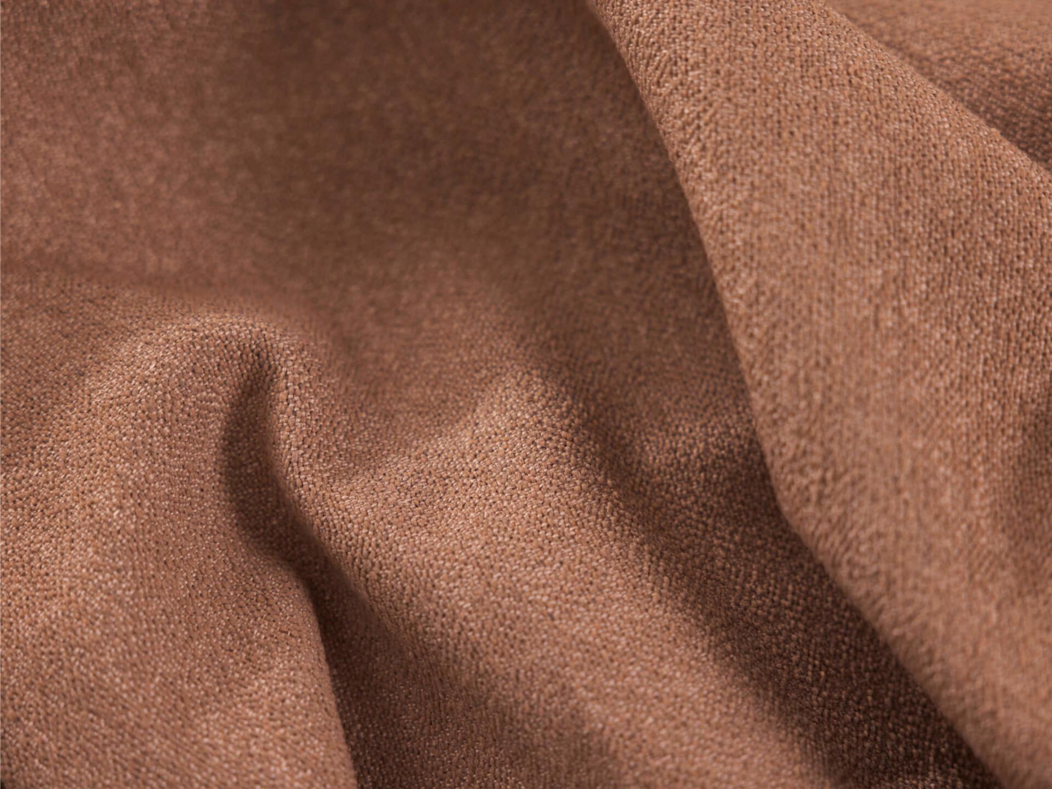 A soft, textured fabric in a warm brown tone, showcasing gentle folds and a smooth surface.