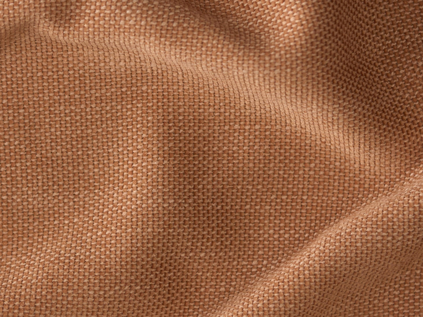 Close-up of premium woven fabric in warm terracotta, showcasing rich texture and fine craftsmanship, ideal for modern high-end upholstery applications.