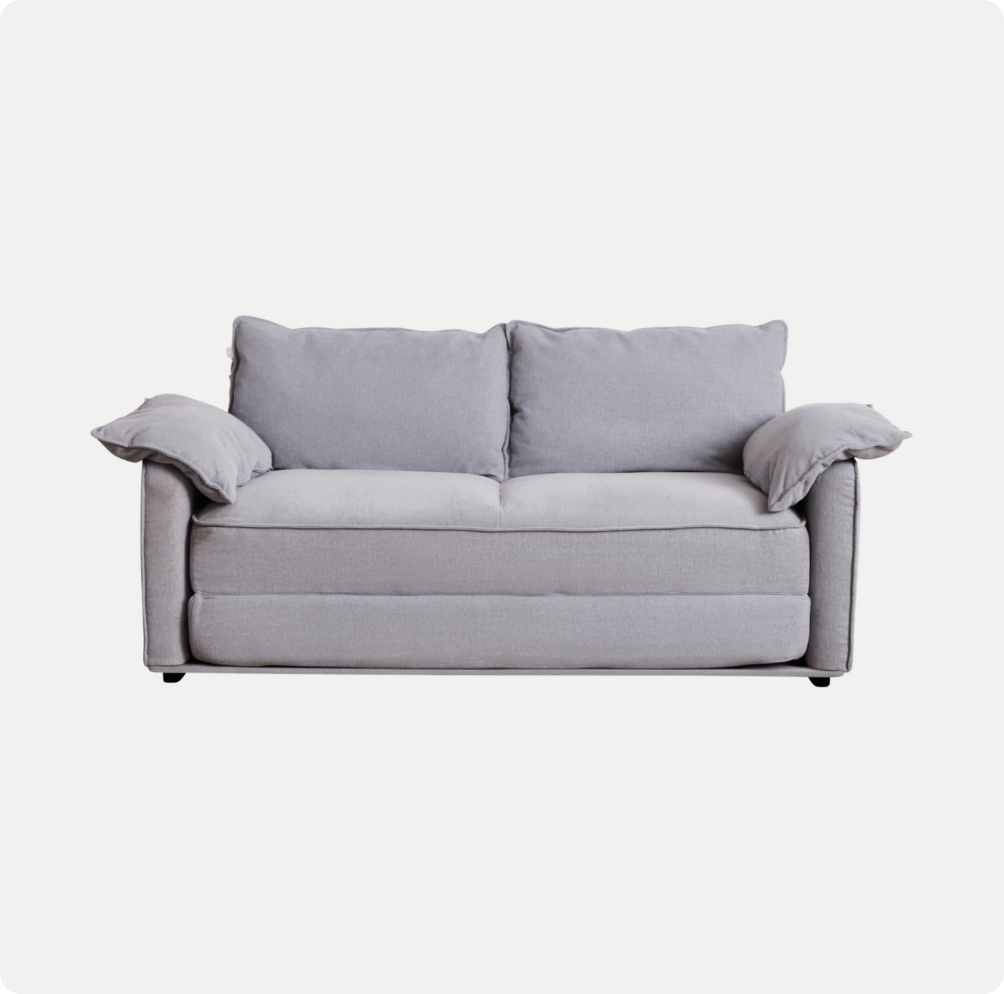 A light grey sofa with two back cushions and two arm cushions, featuring a minimalist design and plush fabric.