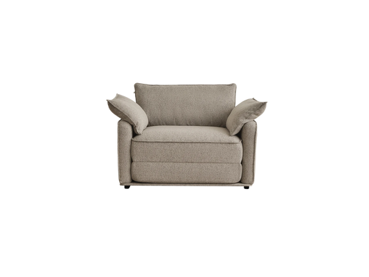 A cozy, light beige armchair with two soft, fluffy armrest cushions, featuring a textured fabric and a modern design.