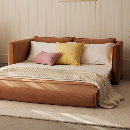 tan sofa bed flipped out to a mattress in room