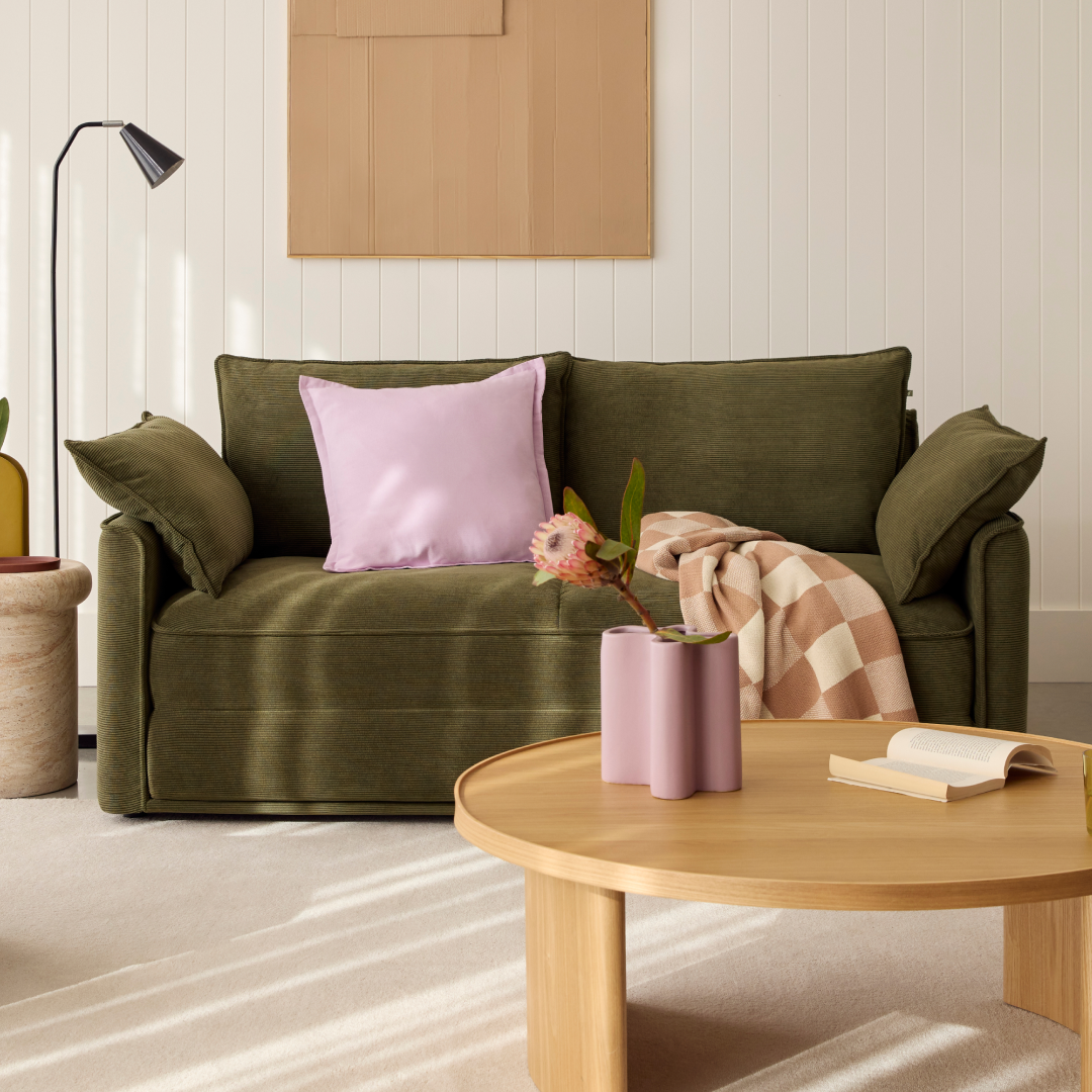 dark green sofa bed in well lit living room