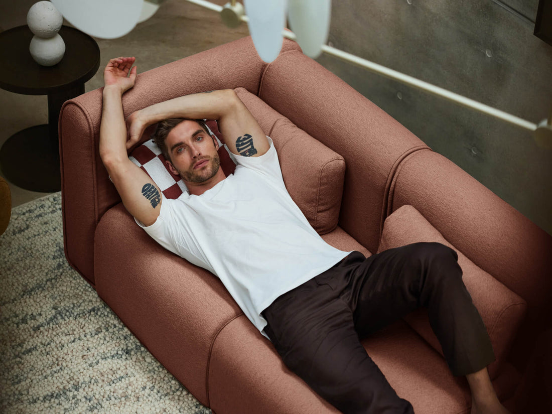 Man sitting on sectional sofa in cozy living room