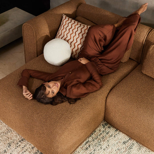 Woman relaxing on brown sectional