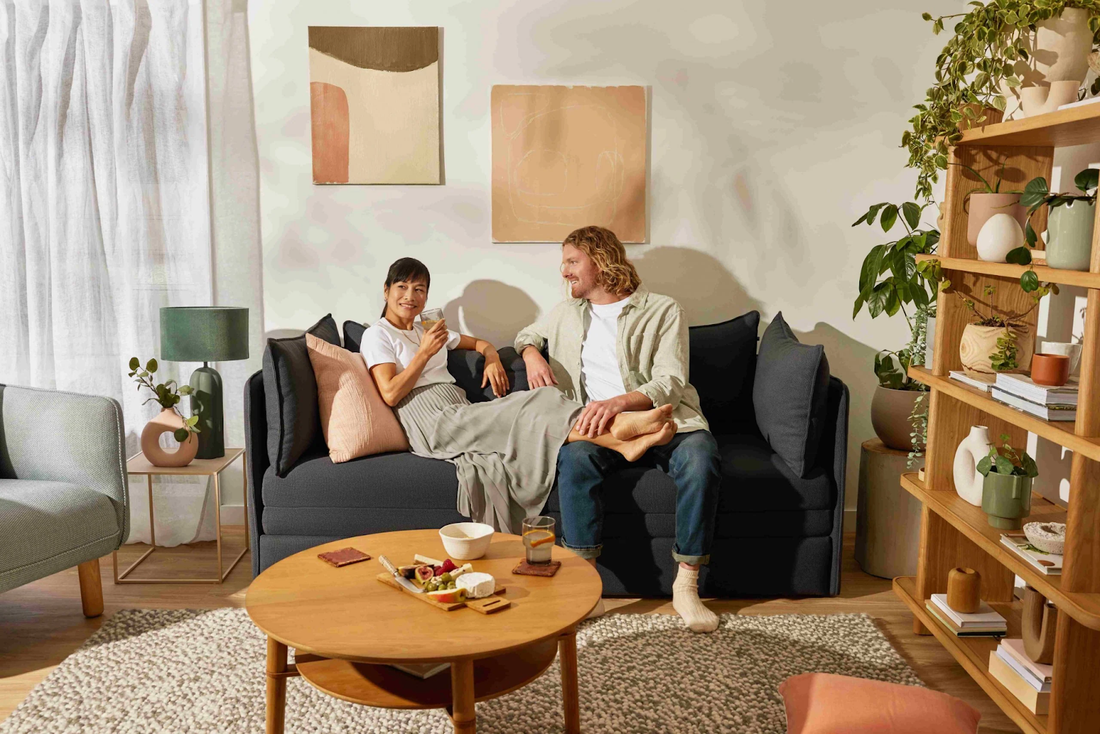 two people sitting on sleeper sofa