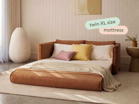 brown twin sleeper sofa laid out with pillows