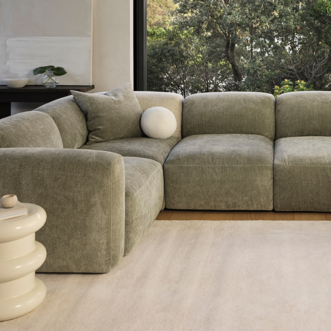 beautiful green modular sofa in a modern living room