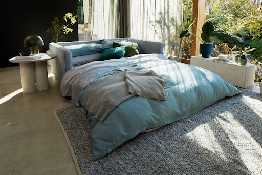 sleeper sofa in a sunny corner of a room