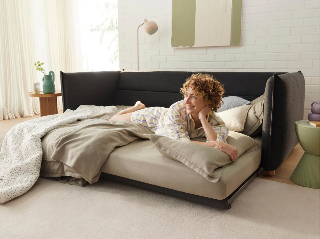 woman lying on sofa bed in living room