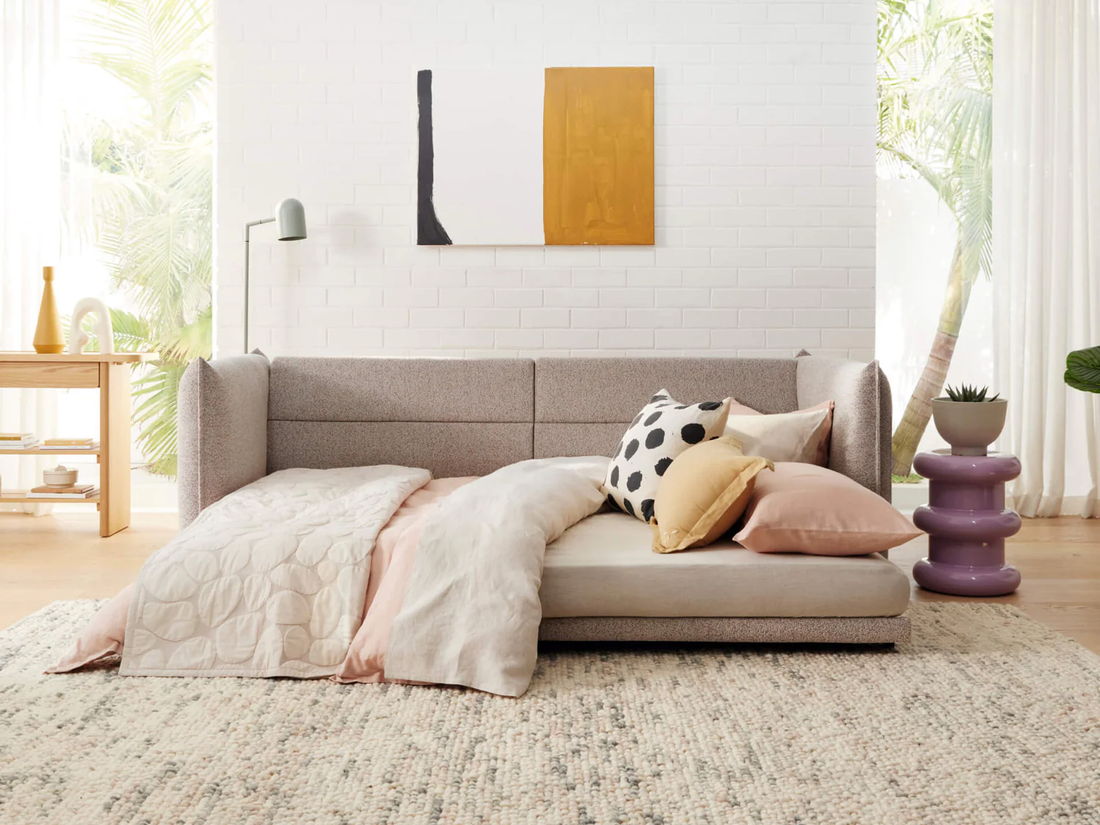 modern sofa bed with blanket and pillows focal point of the room