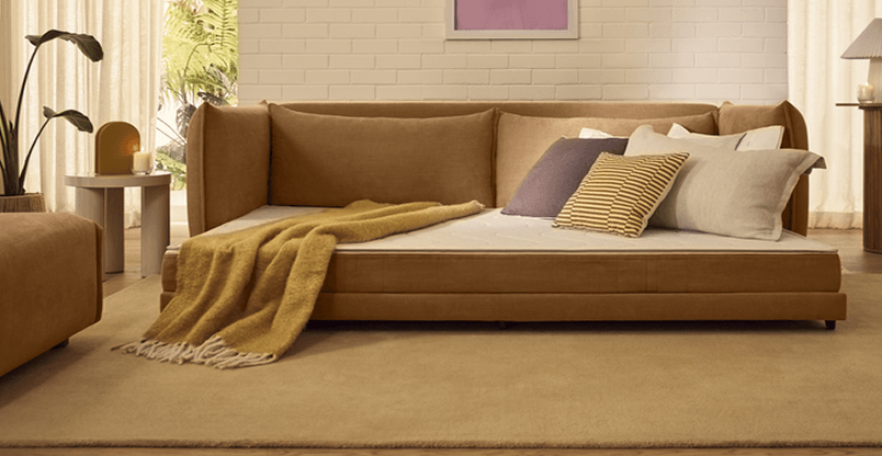 brown sleeper sofa folded out in living room