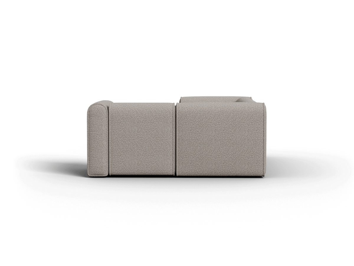 Contemporary grey fabric sofa, modular design with plush cushions and minimalist profile, set in a sophisticated space.