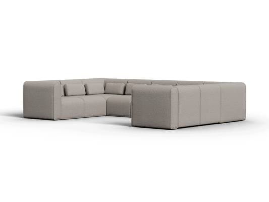 Modular sectional sofa in soft beige fabric, featuring plush cushions and rounded edges, set in a contemporary living room, offering versatile seating.