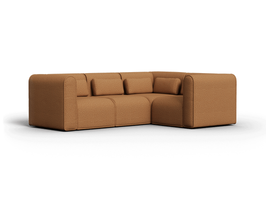 Luxurious L-shaped sofa in rich tan fabric, featuring plush cushions and smooth, rounded edges. Perfect for a modern living room setting.