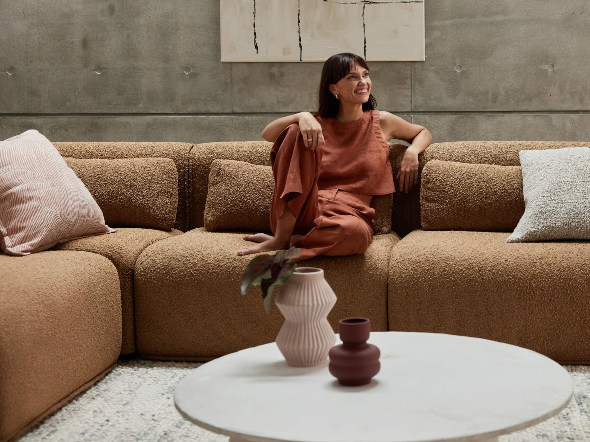 woman smiling on brown sofa