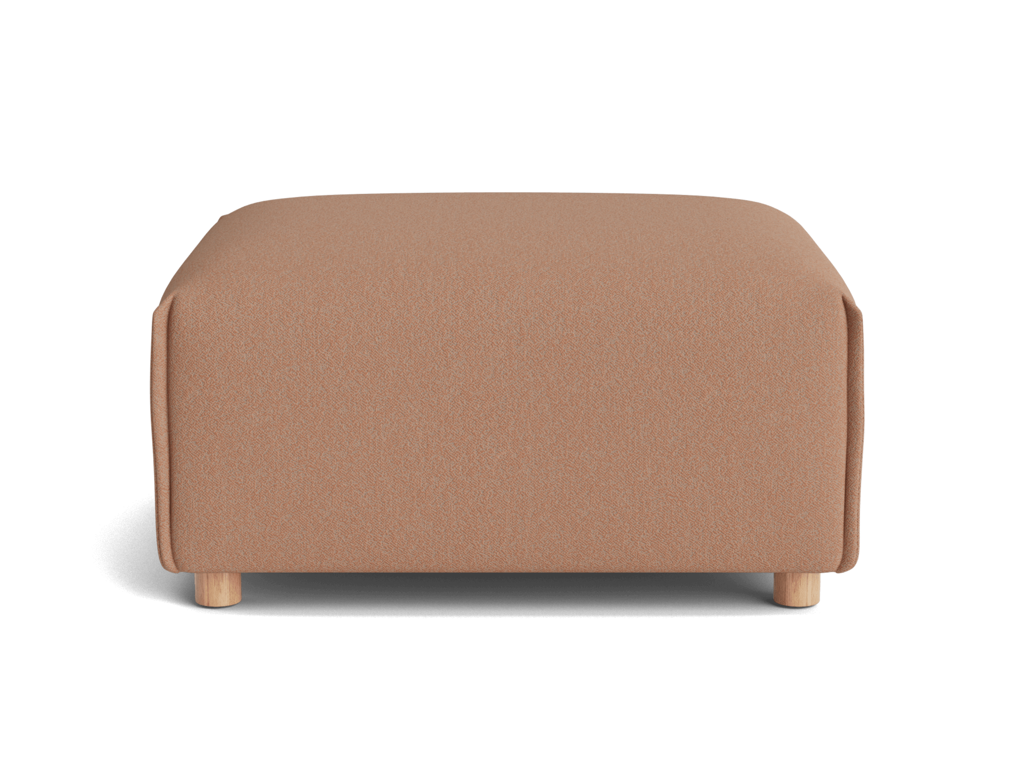 A square, soft ottoman in a warm blush color with light wooden legs, set against a black background.