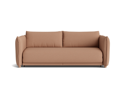 A modern light brown sofa with plush cushions and rounded arms, set against a black background.