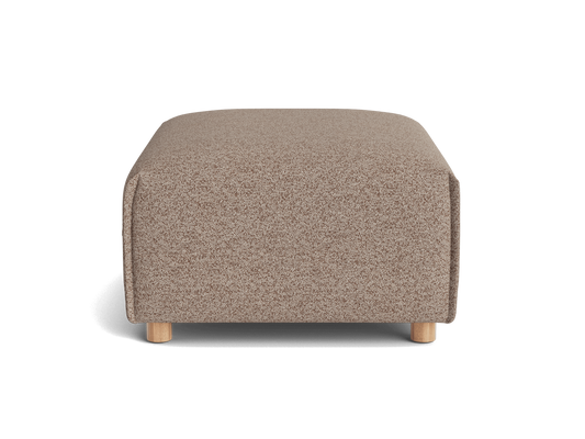 A rectangular, light brown ottoman with textured fabric, resting on four natural wood legs against a black background.