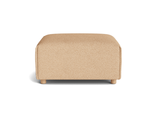 A rectangular pouf in a warm beige hue, featuring rounded edges and short wooden legs, set against a transparent background.