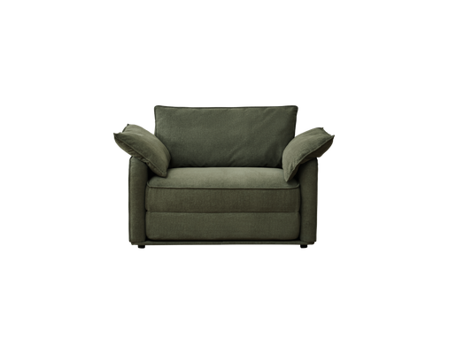 A deep green armchair with two loose cushions, featuring a plush fabric and minimalistic design against a black background.