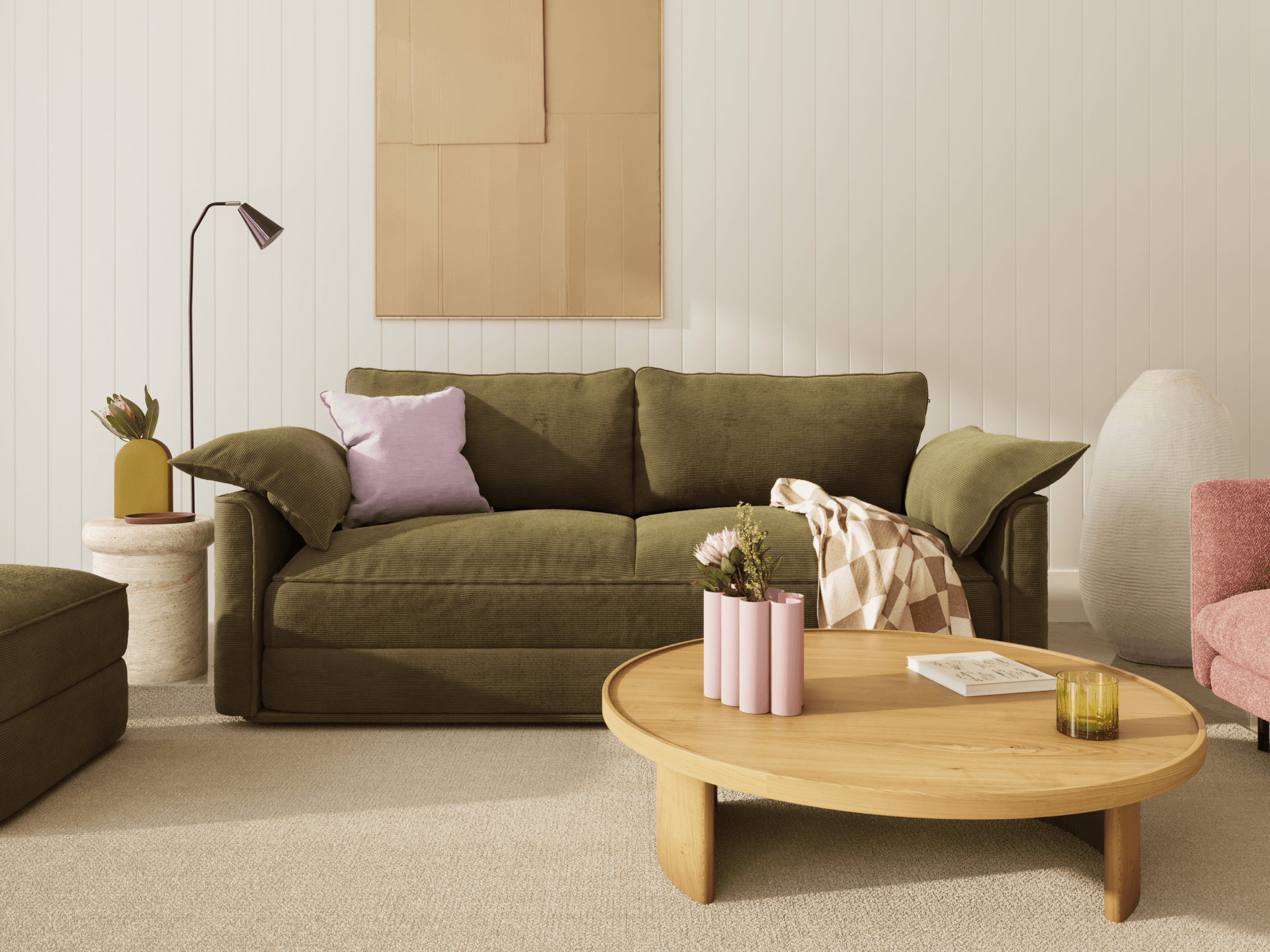 Koala Sofa Bed King in olive green corduroy in styled living room with glass coffee table and cushions