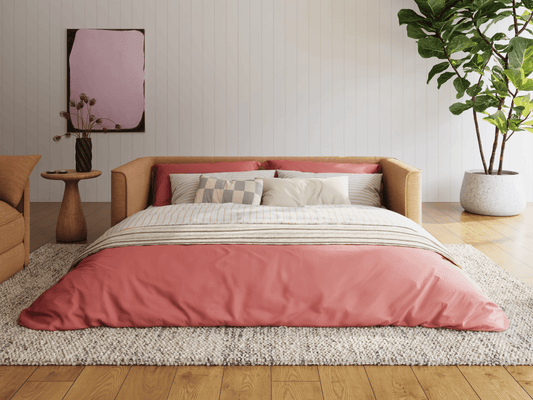 Koala Cushy Sofa Bed in terracotta unfolded into bed mode in styled room