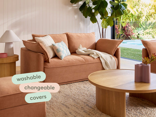 Luxurious terracotta sofa featuring washable, changeable covers. Set in a sunlit lounge with a light timber coffee table and coastal styling.