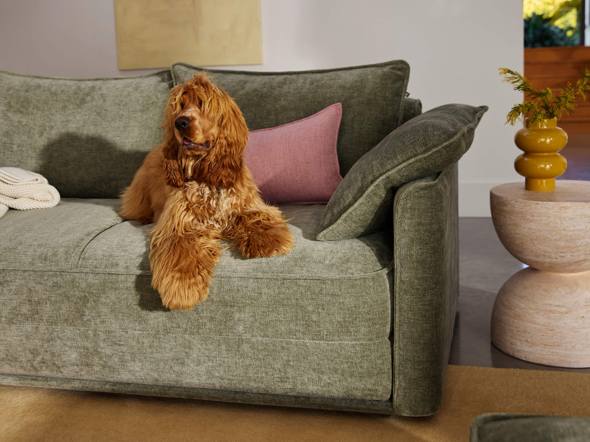 Koala Cushy Sofa Bed in sage green with person relaxing in lifestyle setting