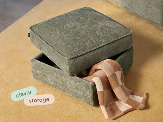 Elegant green fabric ottoman with hidden storage, featuring clean lines and a soft, durable finish. Set atop a plush beige carpet, enhancing modern interiors.