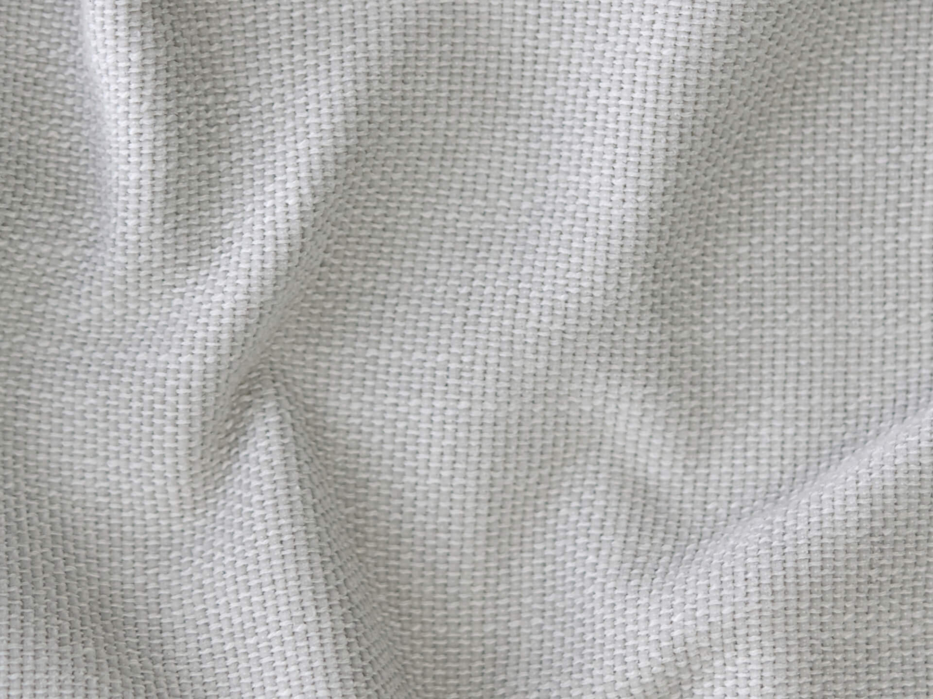 Light grey textured fabric with a soft, woven finish, ideal for modern upholstery projects. Offers a sophisticated, neutral palette for luxurious interiors.