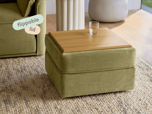 Elevate your space with this olive-green fabric ottoman featuring a natural wood flippable lid. Perfectly suited for modern lounges or refined sitting areas.