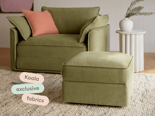 Luxurious olive green armchair and matching ottoman, crafted in premium fabric. Features plush cushions and boxy design in a serene, modern living space.