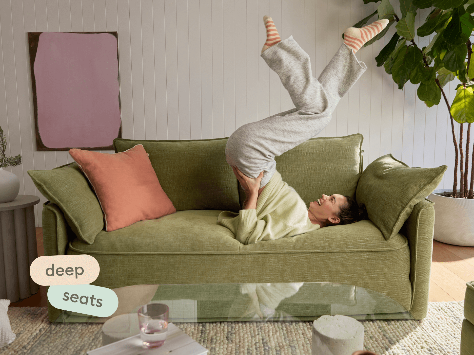 Olive green Koala sofa bed with deep 23.5-inch seats and angled backrest in a styled living room