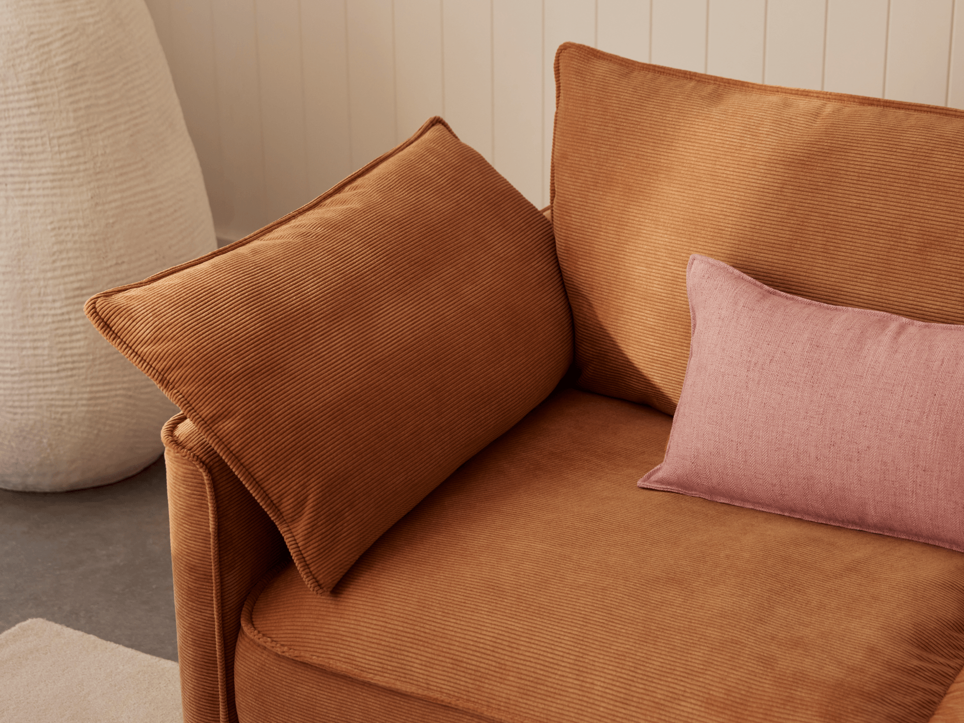 Koala Sofa Bed King in terracotta corduroy close-up with washable changeable fabrics text overlay