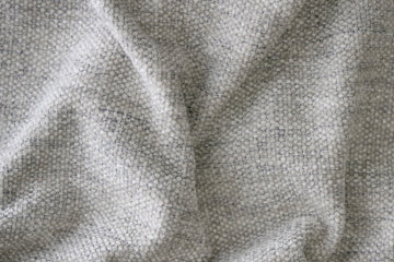 Textured grey fabric with a woven finish, crafted for premium upholstery. Elegant and durable, perfect for modern sofas or armchairs in minimalist settings.
