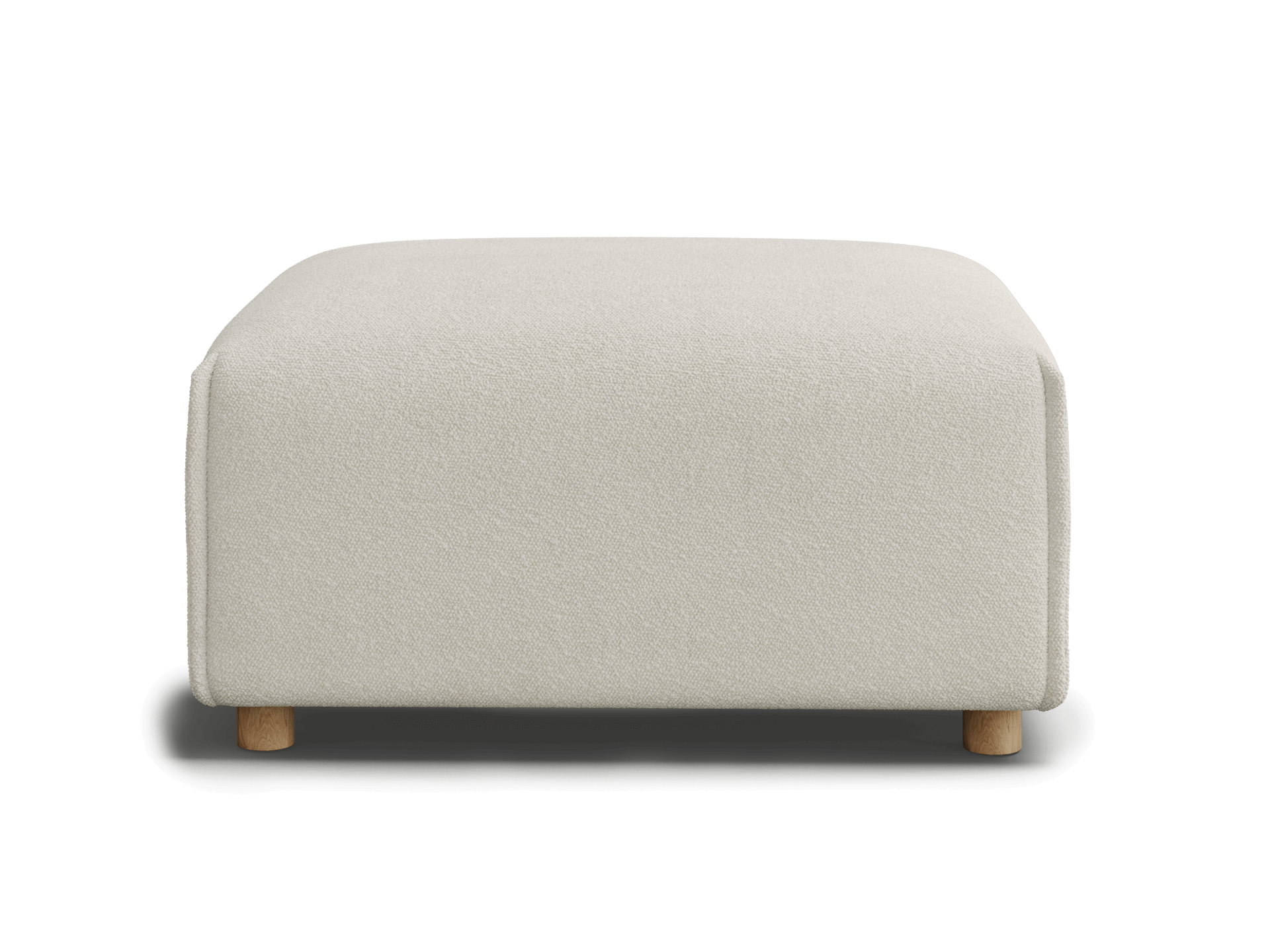 A cream-colored upholstered ottoman with a soft texture and light wooden legs, set against a black background.