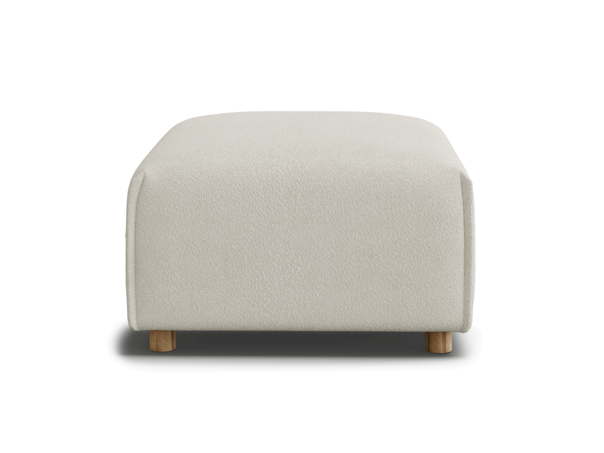 A light beige ottoman with rounded edges sits on small wooden legs against a black background.