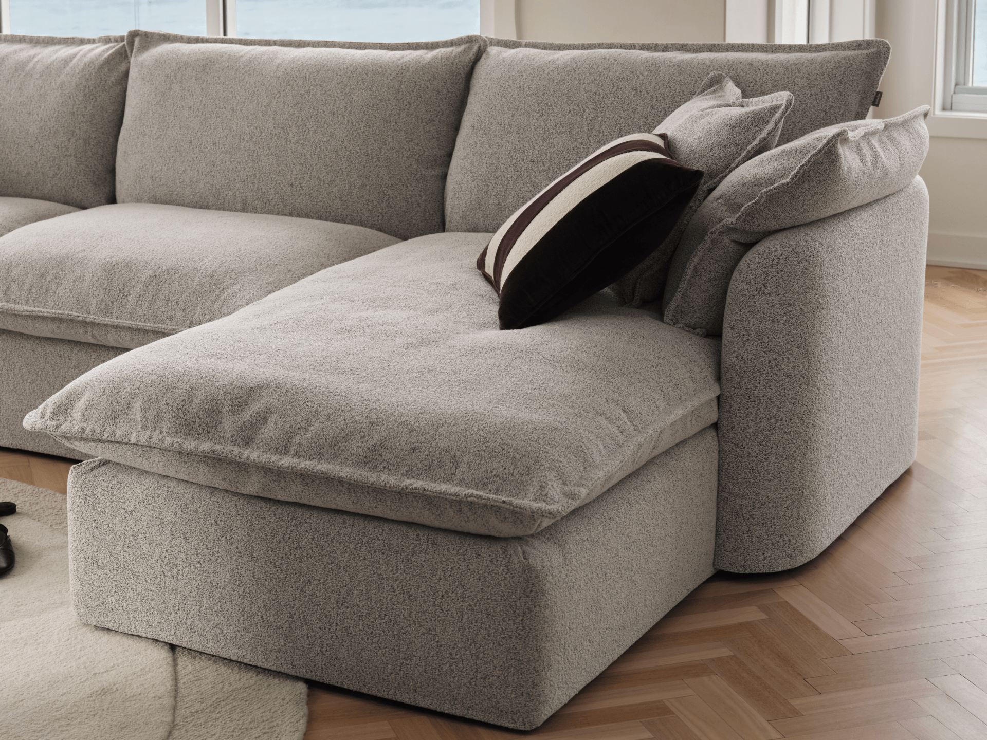 Koala Tamarama 2-section chaise modular sofa in Aussie Latte, with monstera plant and terracotta velvet cushion