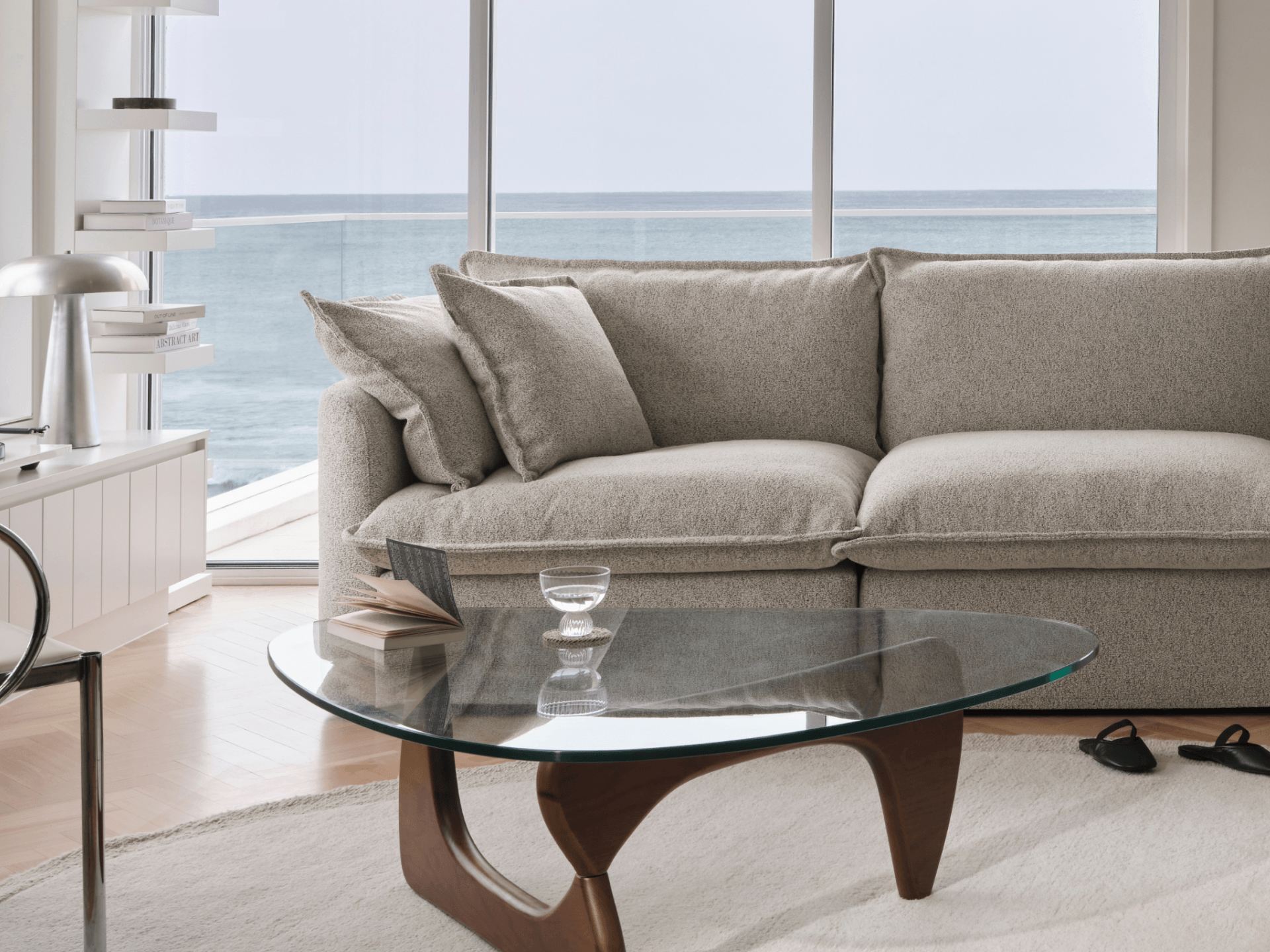 Koala Tamarama 2-section modular sofa in Aussie Latte, in coastal living room with ocean view and glass table