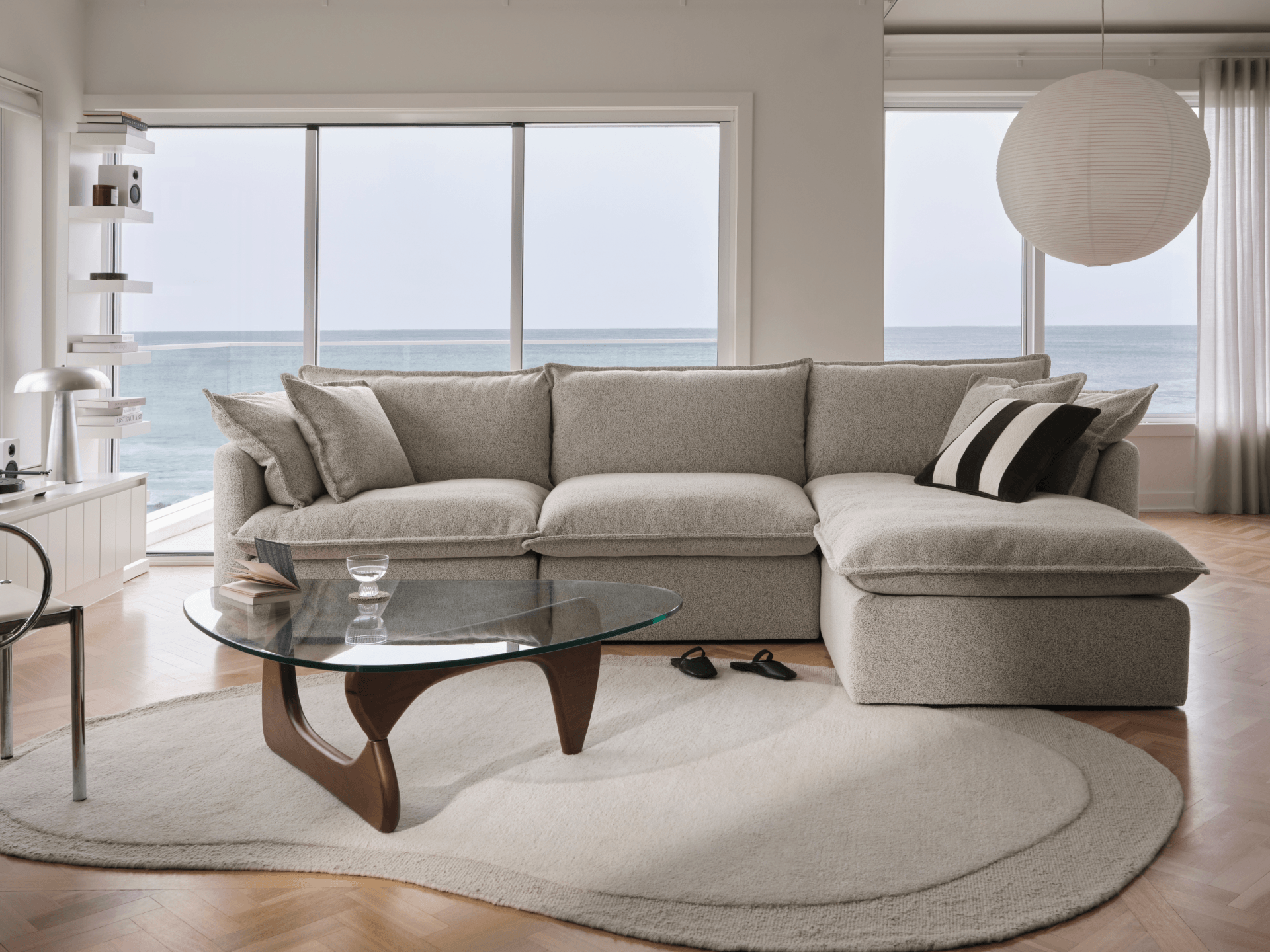 Koala Tamarama 3-section chaise modular sofa in Aussie Latte, with monstera plant and Noguchi glass table