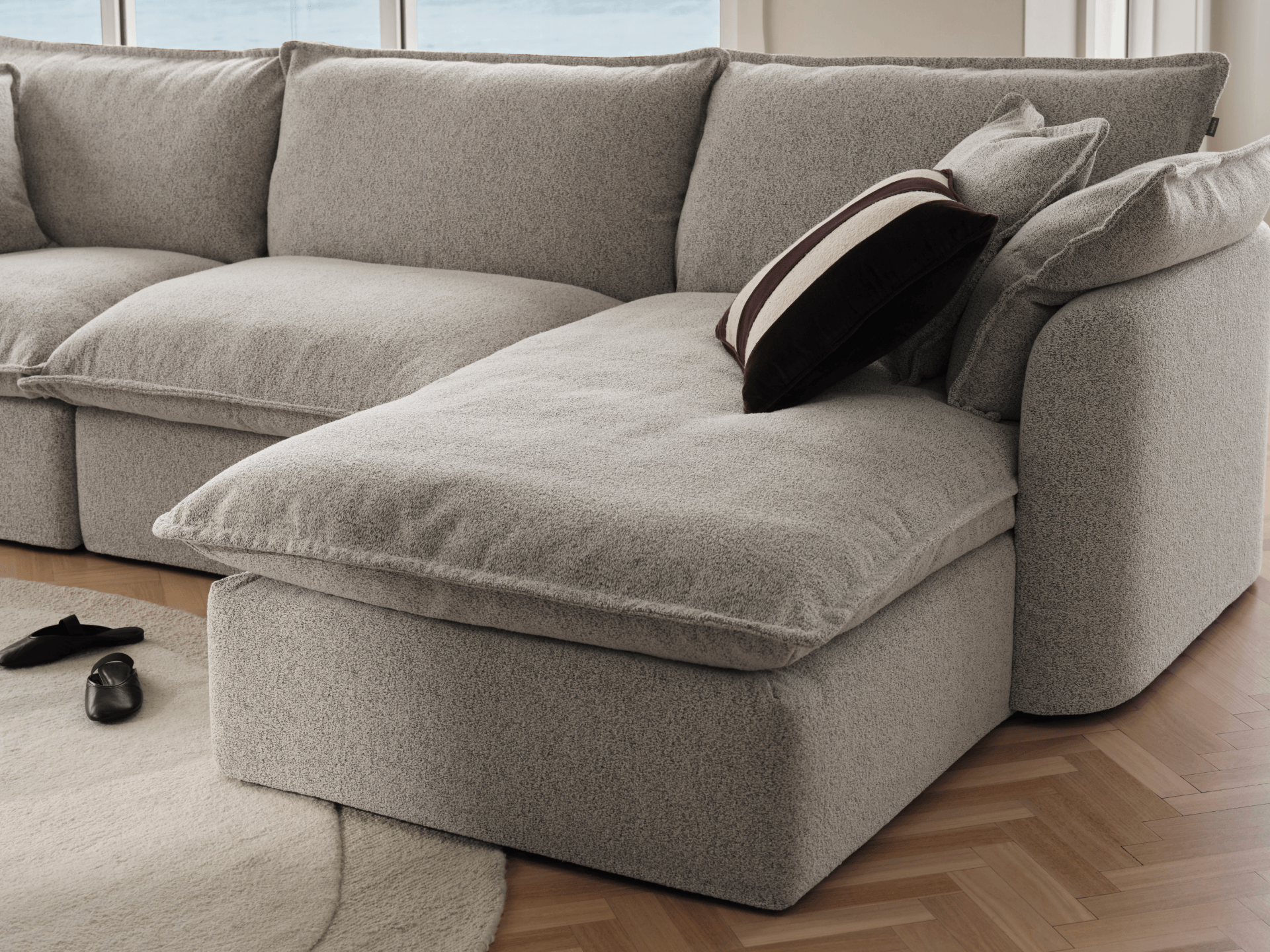 Koala Tamarama 4-section chaise modular sofa in Aussie Latte, with monstera plant and Noguchi glass table
