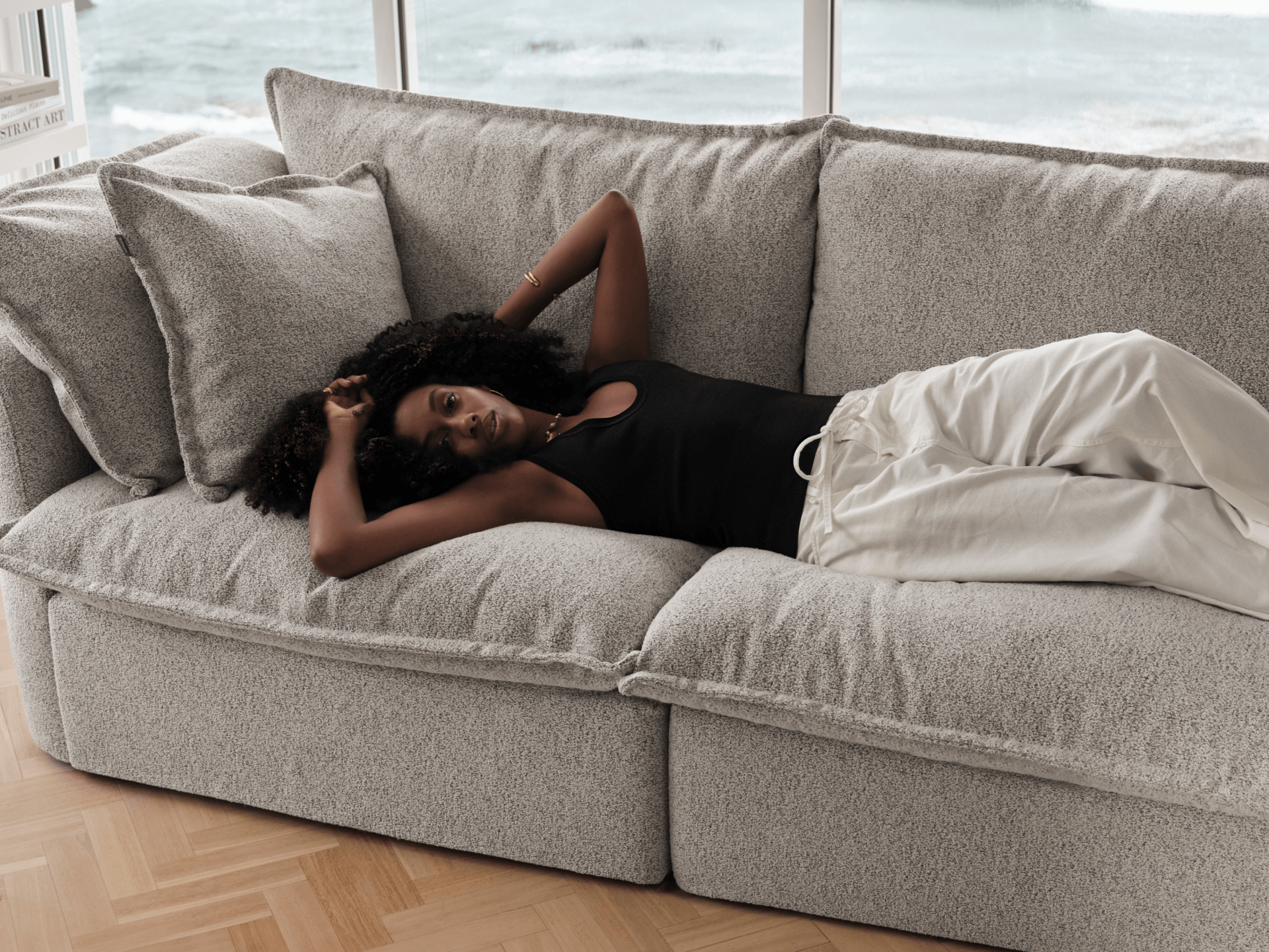 Koala Tamarama 4-section L-shape sectional in Aussie Latte, with terracotta velvet cushion and city view