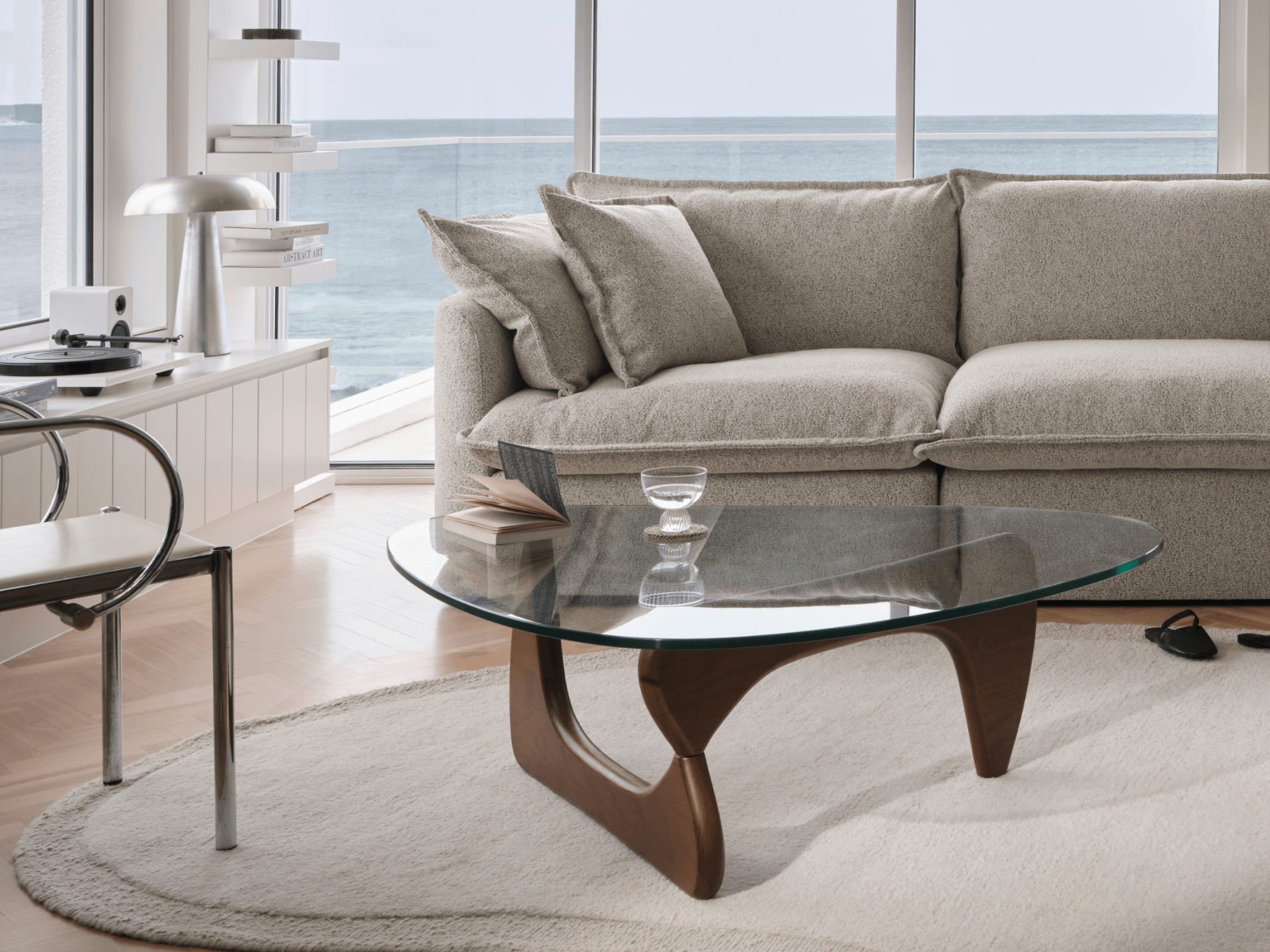 Almond Koala Tamarama 4-section L-shape corner sofa in coastal living room with ocean view and glass table