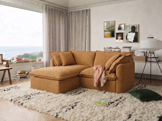 Brown sectional sofa in a living room with a large window and decorative items.