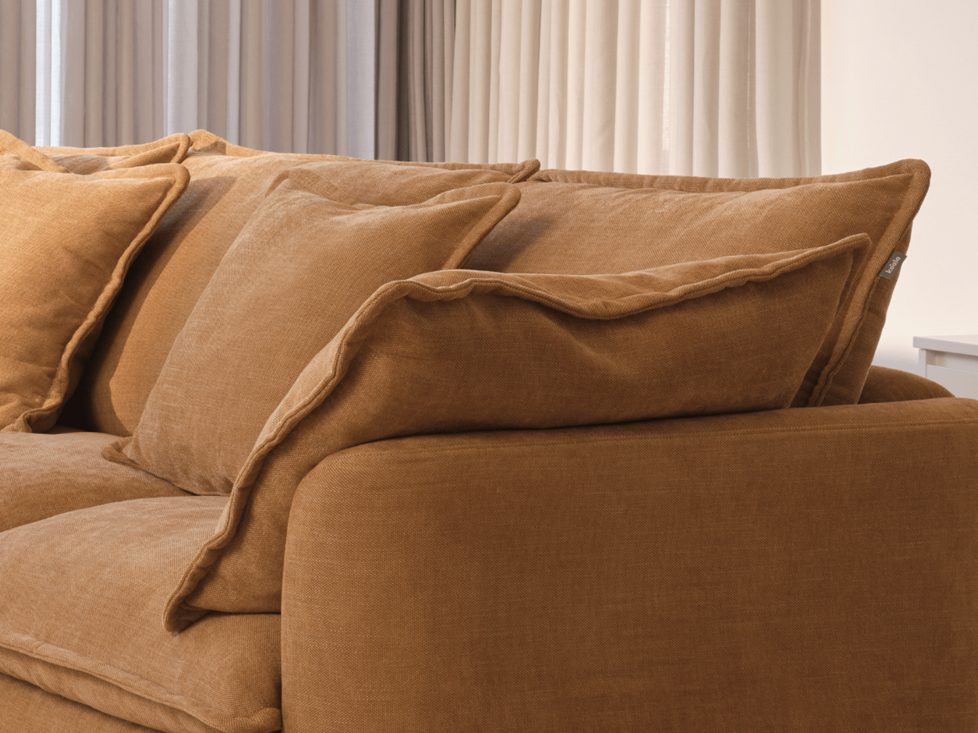 Koala Tamarama 2-section modular sofa in Bronzed Aussie, linen scatter cushions with sunlit art books