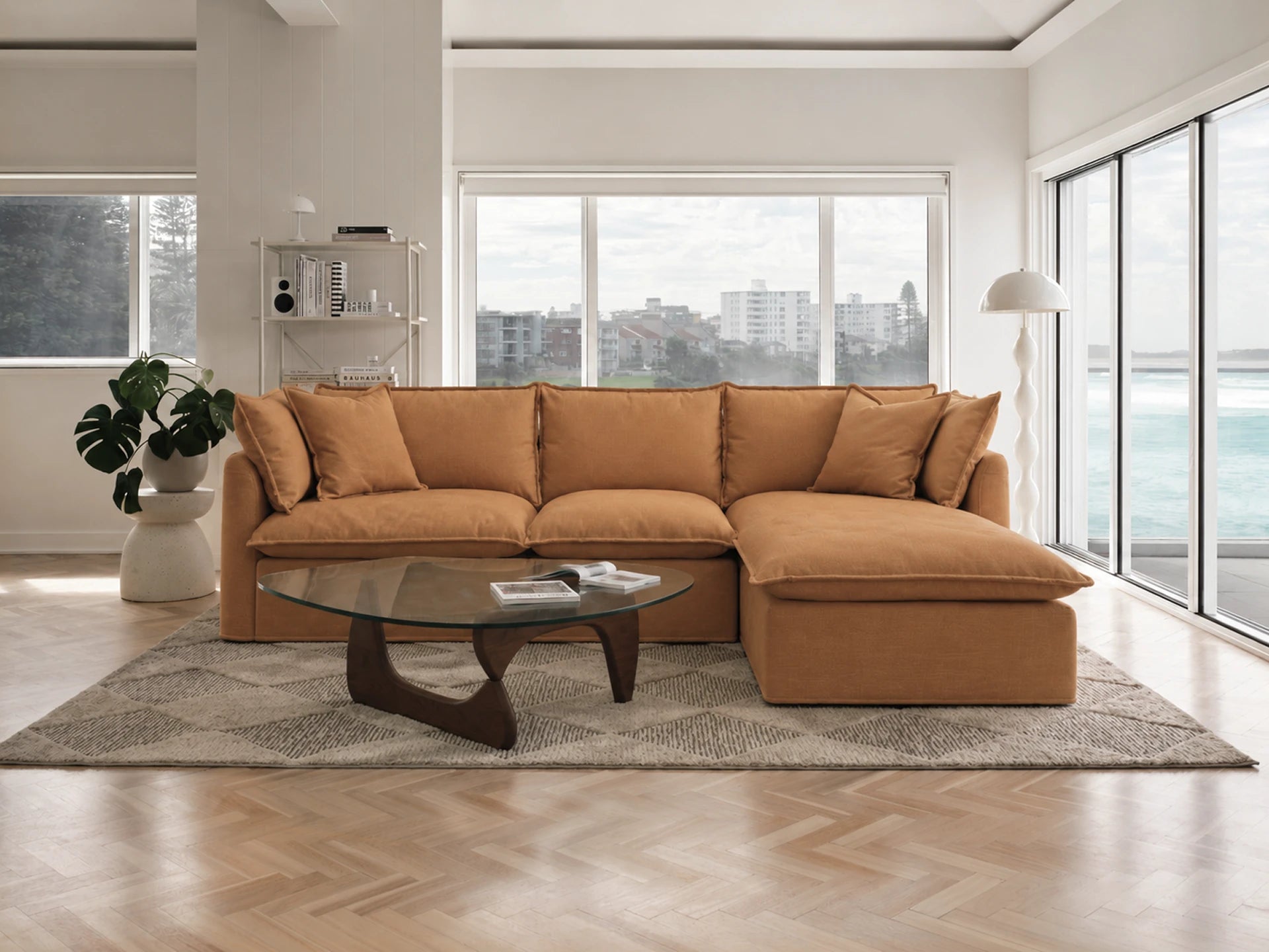 Brown sectional sofa in a modern living room with large windows.