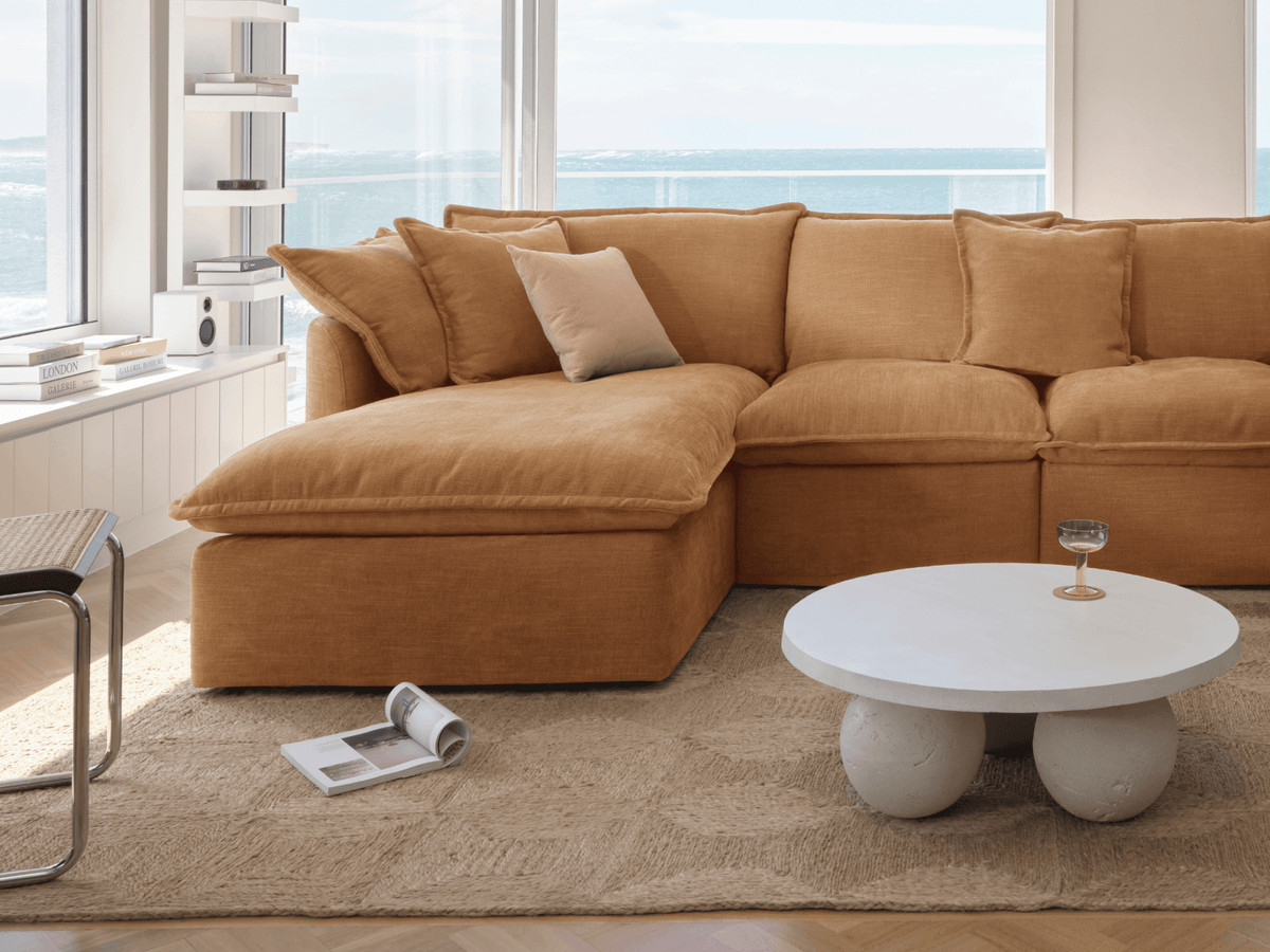 Koala Tamarama 4-section chaise modular sofa in Bronzed Aussie, with monstera plant and Noguchi glass table