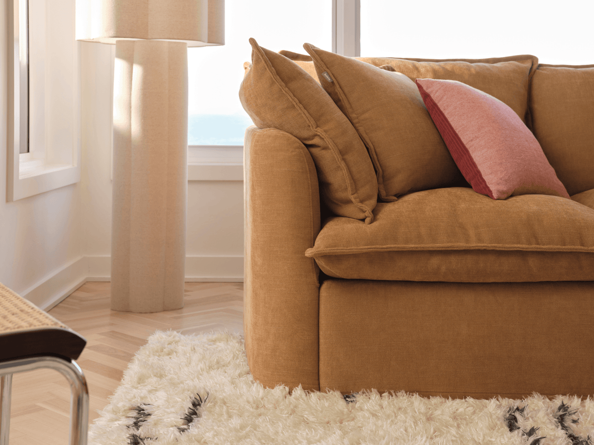 Koala Tamarama 4-section chaise modular sofa in Bronzed Aussie, linen scatter cushions with sunlit art books