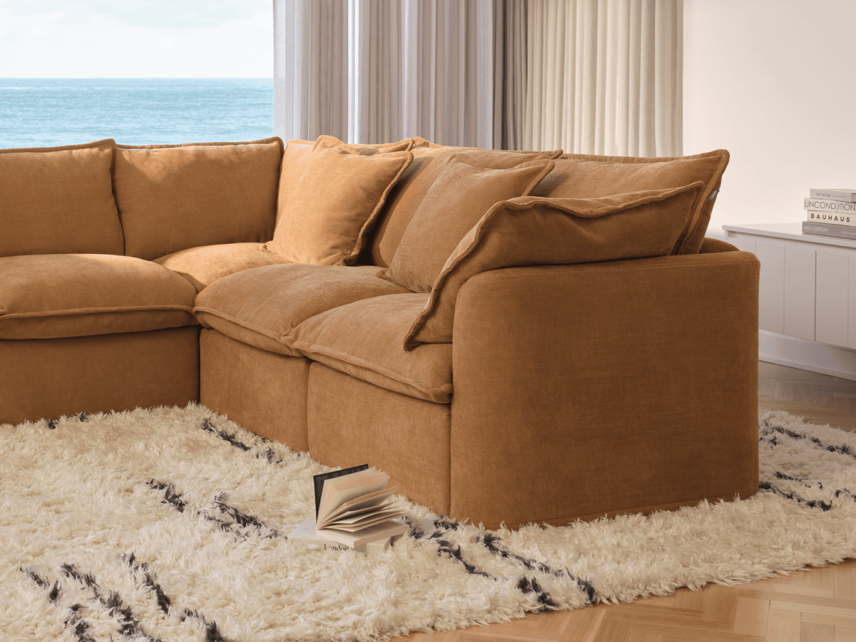 Koala Tamarama 4-section L-shape sectional in Bronzed Aussie, with terracotta velvet cushion and city view