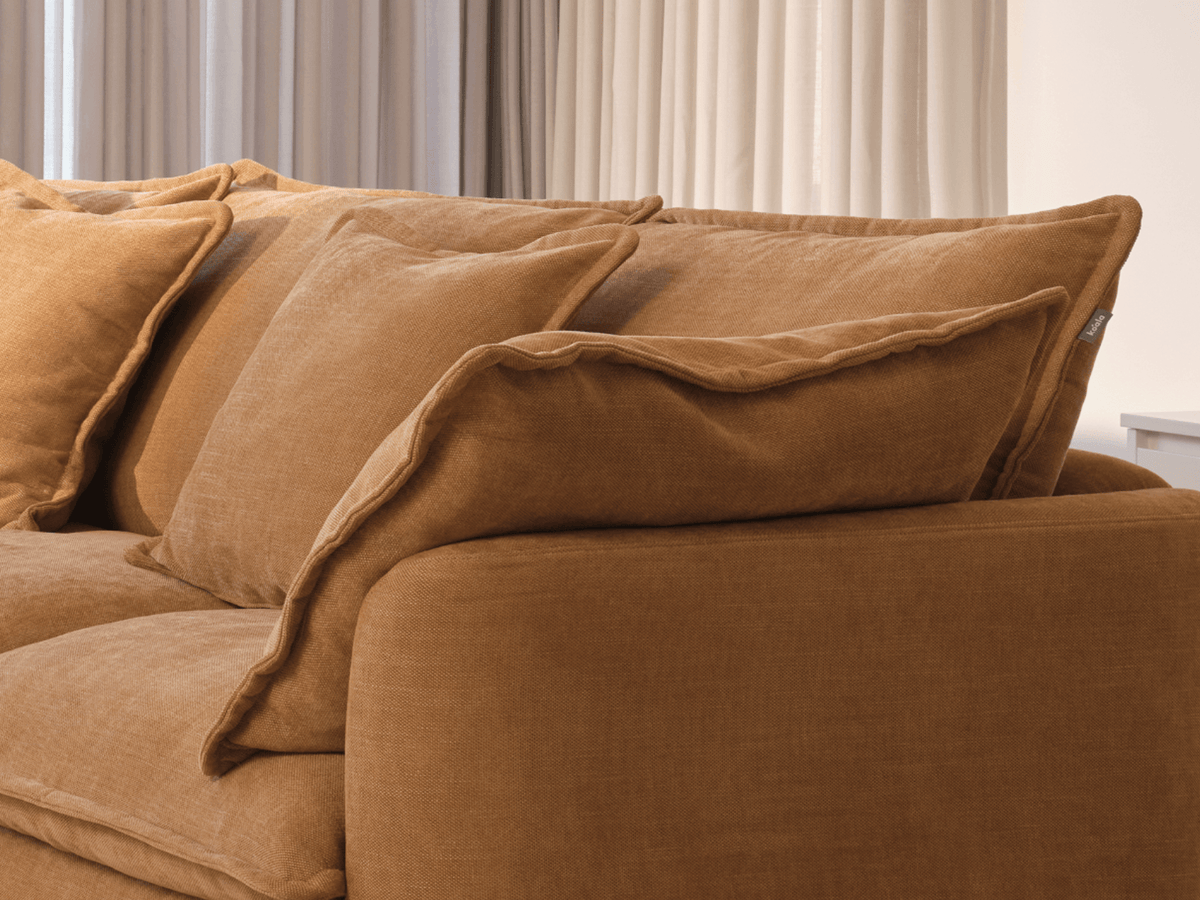 Koala Tamarama 4-section modular sofa in Bronzed Aussie, linen scatter cushions with sunlit art books